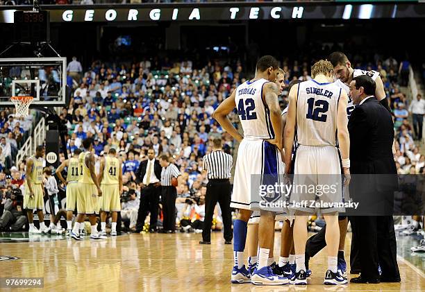 Mike Krzyzewski, head coach of the Duke Blue Devils confers with players during a timeout against the Georgia Tech Yellow Jackets in the championship...