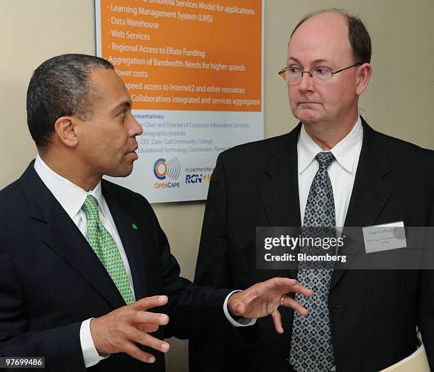 Deval Patrick, governor of Massachusetts, left, talks to Dan Gallagher, chairman of OpenCape Corp., at a news conference announcing the $32 million...