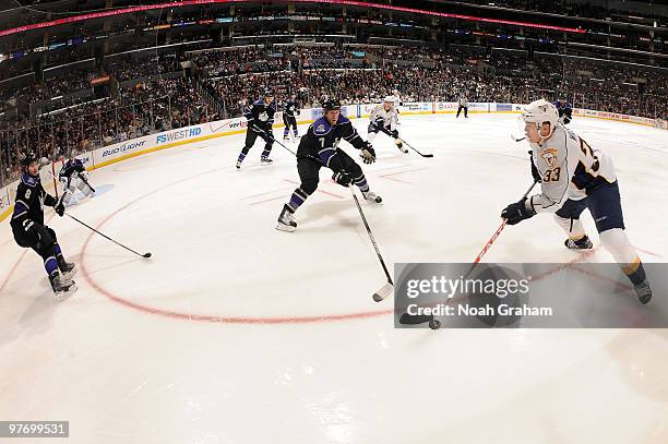 Colin Wilson of the Nashville Predators skates with the puck against Rob Scuderi of the Los Angeles Kings on March 14, 2010 at Staples Center in Los...