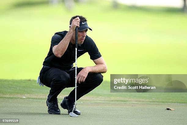 Charl Schwartzel of South Africa lines up a putt on the first hole during the final round of the 2010 WGC-CA Championship at the TPC Blue Monster at...