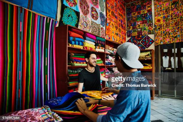 laughing friends shopping in local market while on vacation together - mexico market stock pictures, royalty-free photos & images