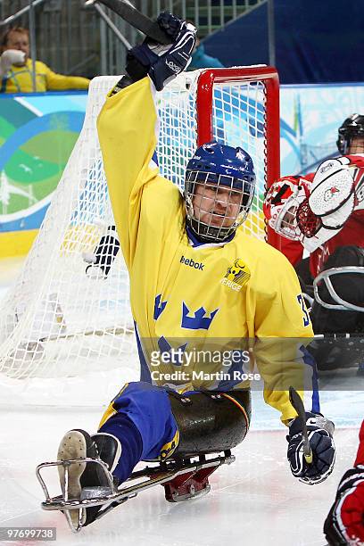 Niklas Ingvarsson of Sweden celebrates his goal against Benoit St-Amand of Canada during the first period of the Ice Sledge Hockey Preliminary Round...