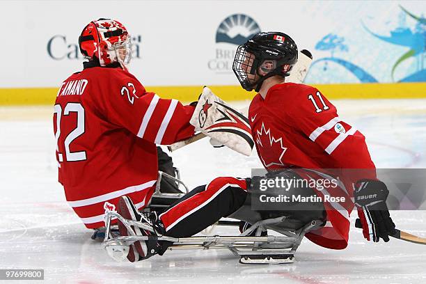 Goal keeper Benoit St-Amand and Adam Dixon of Canada celebrate a goal during the first period of the Ice Sledge Hockey Preliminary Round Group B Game...