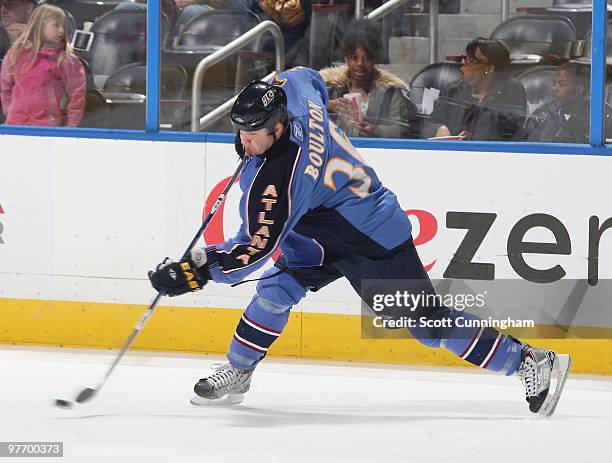 Eric Boulton of the Atlanta Thrashers fires the puck against the Phoenix Coyotes at Philips Arena on March 14, 2010 in Atlanta, Georgia.