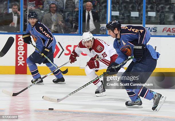 Colby Armstrong of the Atlanta Thrashers carries the puck against Matthew Lombardi of the Phoenix Coyotes at Philips Arena on March 14, 2010 in...