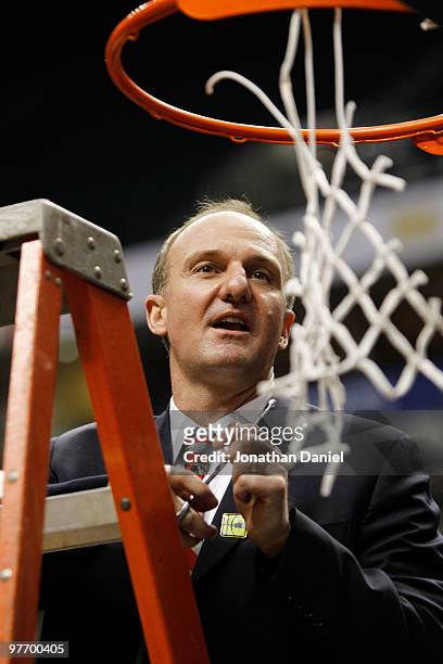 Head coach Thad Matta of the Ohio State Buckeyes cuts down the net after winning the championship game in the Big Ten Men's Basketball Tournament...