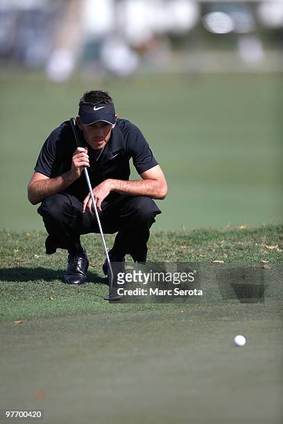 Charl Schwartzel of South Africa lines up a putt on the eighth hole during the final round of the 2010 WGC-CA Championship at the TPC Blue Monster at...