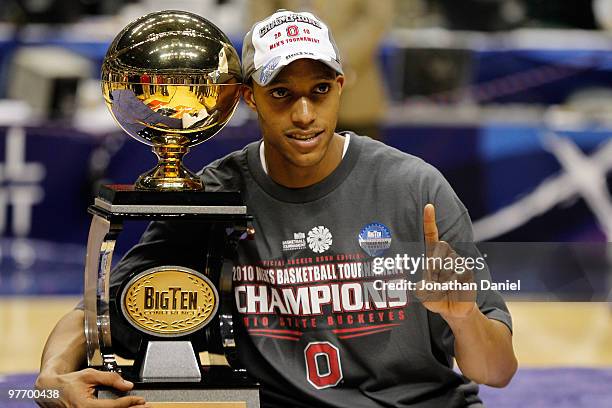 Guard Evan Turner of the Ohio State Buckeyes celebrates with the Big Ten tournament championship trophy after winning the Big Ten Men's Basketball...