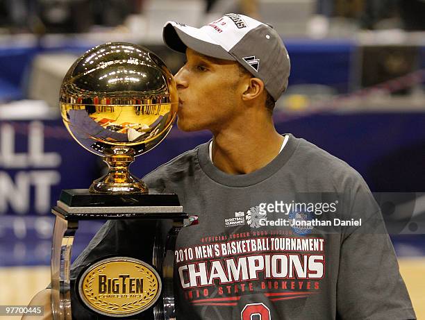 Guard Evan Turner of the Ohio State Buckeyes celebrates by kissing the Big Ten tournament championship trophy after winning the Big Ten Men's...