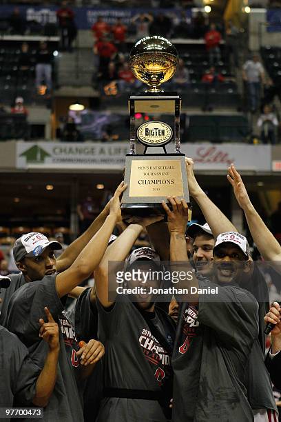 Guard Evan Turner, Mark Titus and David Lighty of the Ohio State Buckeyes lift the Big Ten tournament championship trophy after winning the Big Ten...