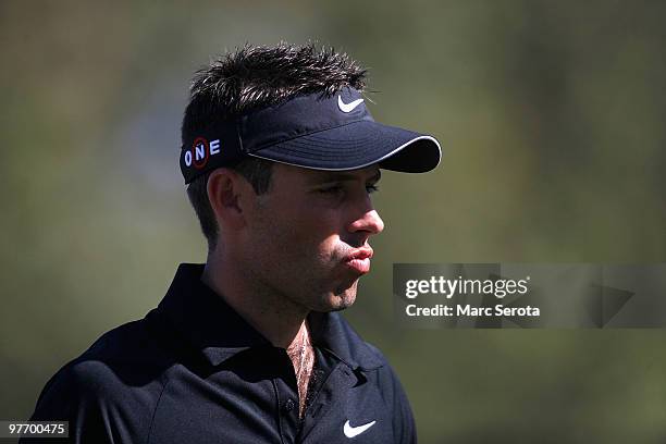 Charl Schwartzel of South Africa waits to play his shot on the eighth hole during the final round of the 2010 WGC-CA Championship at the TPC Blue...