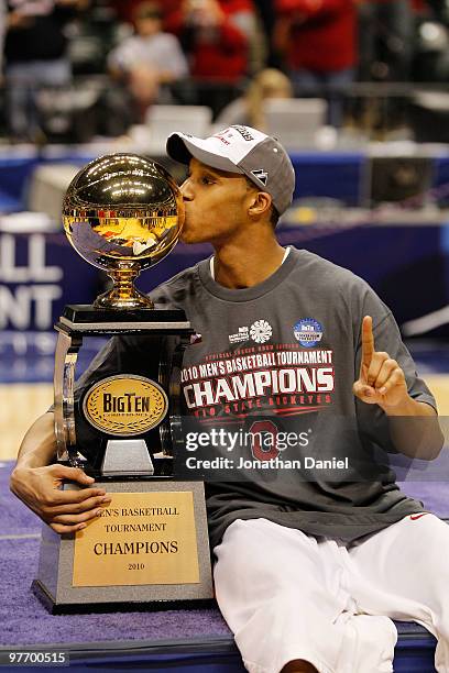 Guard Evan Turner of the Ohio State Buckeyes celebrates by kissing the Big Ten tournament championship trophy after winning the Big Ten Men's...