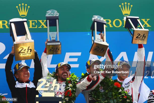 The Toyota Gazoo Racing TS050 Hybrid team of Fernando Alonso, Sebastien Buemi and Kazuki Nakajima celebrate alongside Shigeki Tomoyama of Toyota...