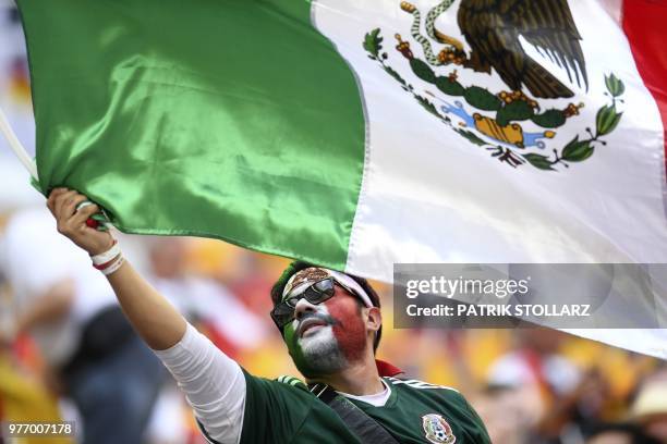 Mexico's fan waves a Mexican national flag as he cheers prior to the Russia 2018 World Cup Group F football match between Germany and Mexico at the...