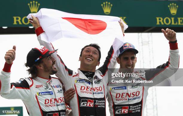 The Toyota Gazoo Racing TS050 Hybrid team of Fernando Alonso, Kazuki Nakajima and Sebastien Buemi celebrate after Toyota win for the first time at...