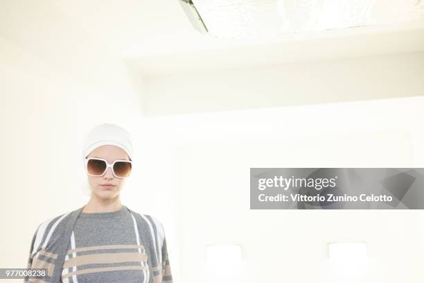 Model is seen backstage ahead of the Daks show during Milan Men's Fashion Week Spring/Summer 2019 on June 17, 2018 in Milan, Italy.