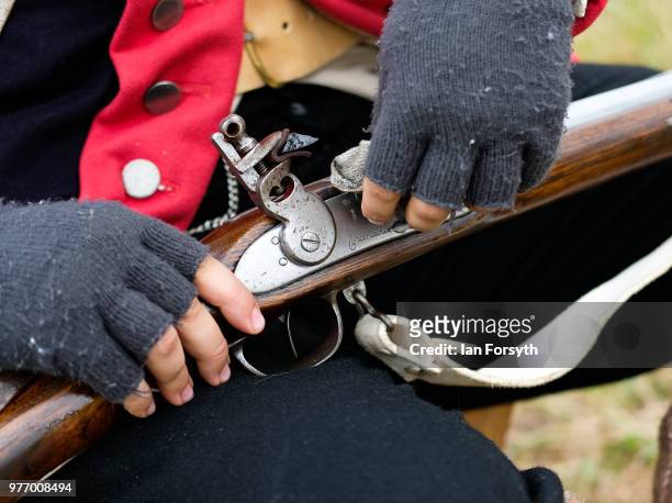 Re-enactor depicting life as a British Red Coat cleans his rifle during the Frontline Sedgefield living history event on June 17, 2018 in Durham,...