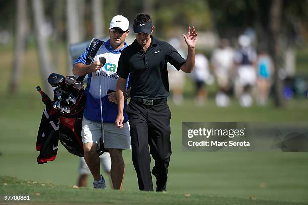 Charl Schwartzel of South Africa waves to the gallery on the eighth hole during the final round of the 2010 WGC-CA Championship at the TPC Blue...