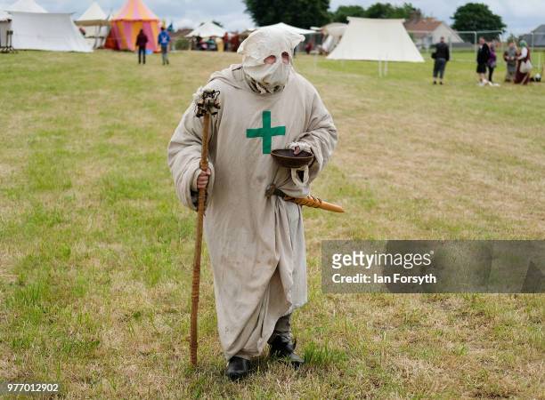 Re-enactor dressed as a leper walks across the showground during the Frontline Sedgefield living history event on June 17, 2018 in Durham, England....