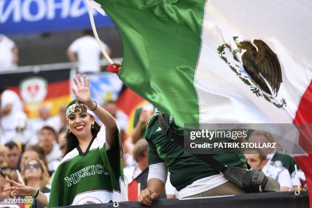 Mexico's fan cheers next to a Mexican national flag prior to the Russia 2018 World Cup Group F football match between Germany and Mexico at the...