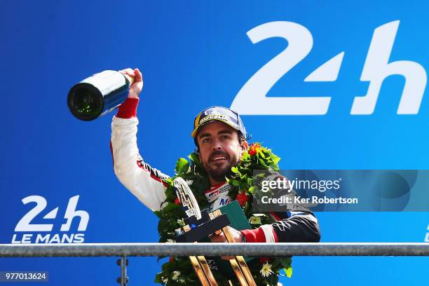 The Toyota Gazoo Racing TS050 Hybrid team driver Fernando Alonso reacts as he and co drivers Kazuki Nakajima and Sebastien Buemi celebrate after...