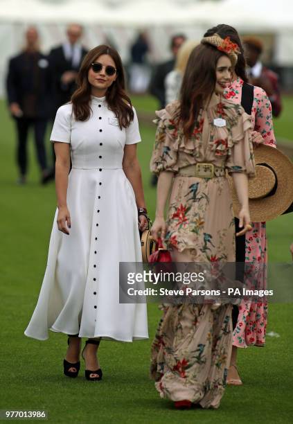 Actresses Jenna Coleman and Lily Collins seen before the start of the Cartier Trophy at the Guards Polo Club, Windsor Great Park, Surrey.