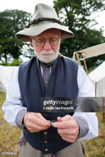 Denis Jarwick from Pittington checks his pocket watch as he depicts life as an officer with the 43rd North Carolina during the American Civil War at...