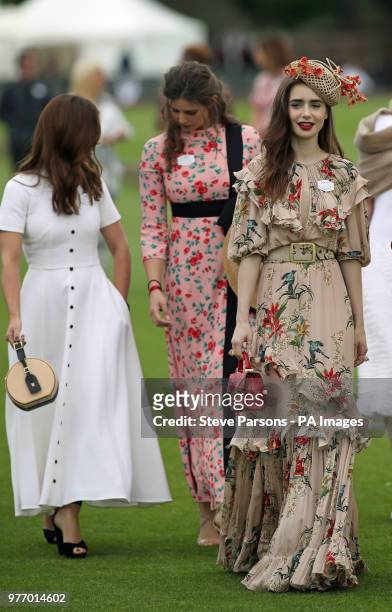 Actresses Jenna Coleman and Lily Collins. Right, seen before the start of the Cartier Trophy at the Guards Polo Club, Windsor Great Park, Surrey.