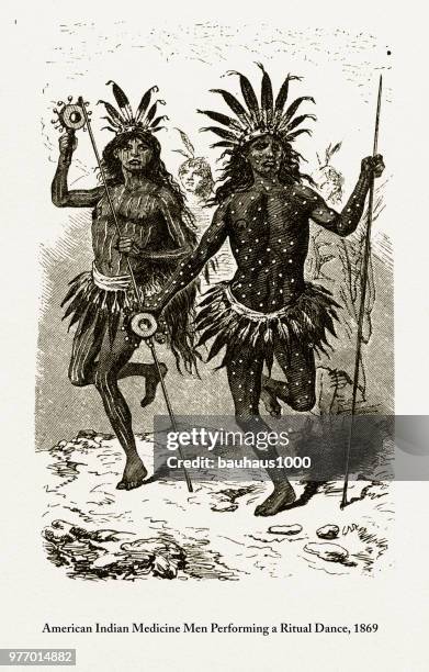 indian medicine men performing a ritual dance engraving, 1869 - shaman headdress stock illustrations