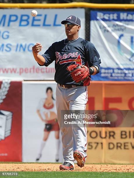 Infielder Yunel Escobar of the Atlanta Braves flips a baseball after a put out against the Toronto Blue Jays March 14, 2010 at the Dunedin Stadium in...