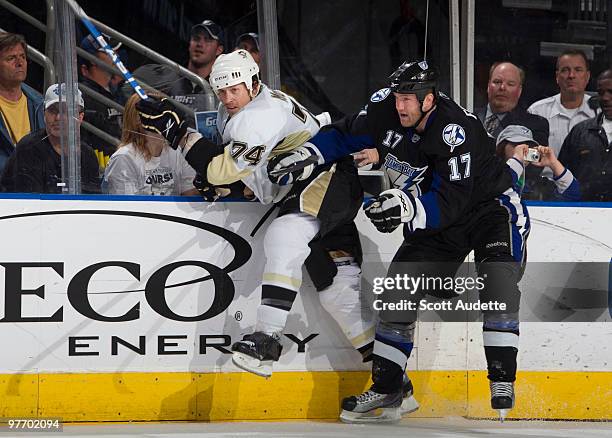 Todd Fedoruk of the Tampa Bay Lightning checks Jay McKee of Pittsburgh Penguins into the boards against at the St. Pete Times Forum on March 14, 2010...