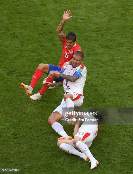 Cristian Gamboa of Costa Rica is challenged by Aleksander Kolarov and Fiilip Kostic of Serbia during the 2018 FIFA World Cup Russia group E match...