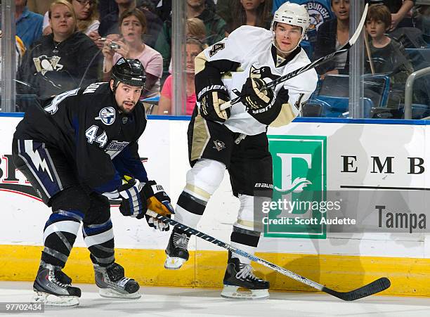 Chris Kunitz of the Pittsburgh Penguins passes the puck against Nate Thompson of the Tampa Bay Lightning at the St. Pete Times Forum on March 14,...