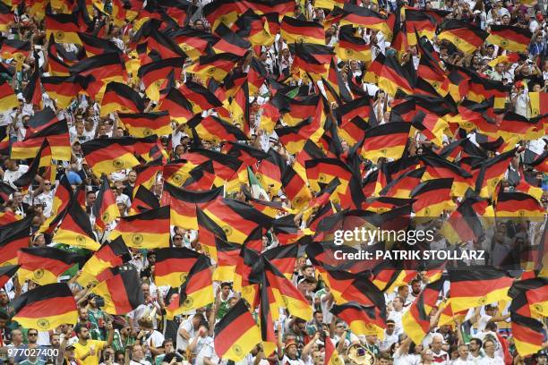 Germany's fans wave German national flags as they cheer prior to the Russia 2018 World Cup Group F football match between Germany and Mexico at the...