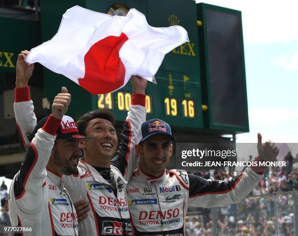 Spain's driver Fernando Alonso, Japanese's Kazuki Nakajima and Swiss' Sebastien Buemi celebrate after winning the 86th Le Mans 24-hours endurance...