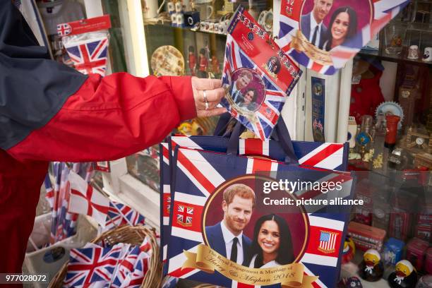 April 2018, Britain, Windsor: Souvenir articles showing prince harry and Meghan Markle for sale in a shop. Prince Harry and the American actress...