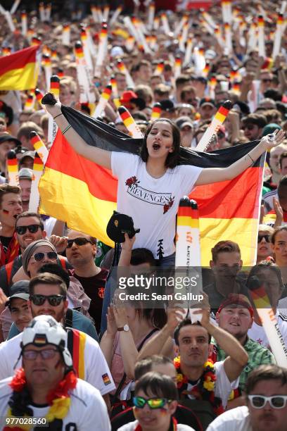 Fans wave German flags at the Fanmeile public viewing area prior to the Germany vs. Mexico 2018 FIFA World Cup match on June 17, 2018 in Berlin,...