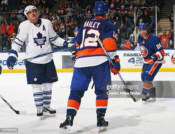 Matt Moulson of the New York Islanders celebrates his third period goal at 7:40 with teammate Josh Bailey as Dion Phaneuf of the Toronto Maple Leafs...