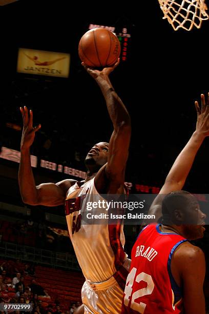 Joel Anthony of the Miami Heat shoots against Elton Brand of the Philadelphia 76ers on March 14, 2010 at American Airlines Arena in Miami, Florida....