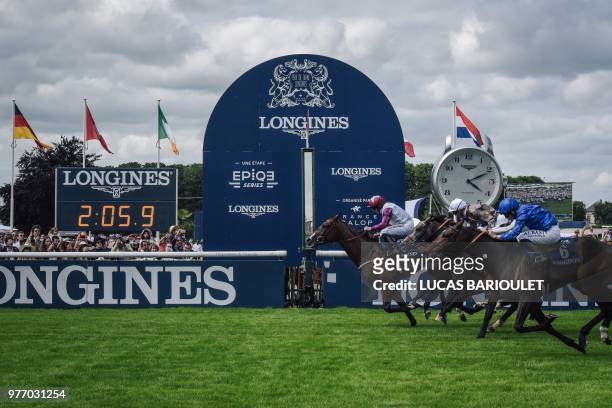 British jockey PJ Mcdonald riding Laurens crosses the finish line to win the 169th edition of the Prix de Diane, ahead French jockey Mickael...