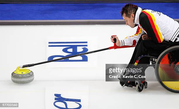 Marcus Sieger releases the stone during the Wheelchair Curling Round Robin game between Germany and the United States on day three of the 2010...