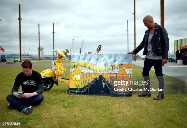 Scooter artist 'Foss' places one of his paintings on display as the 2018 Vespa International World Days event takes place at the Titanic slipways on...
