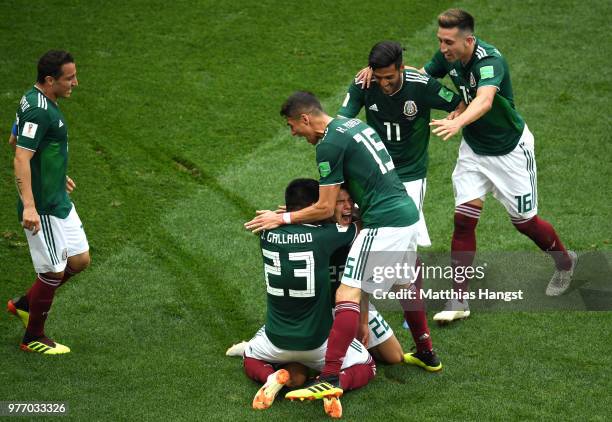 Hirving Lozano of Mexico celebrates with teammates by sliding on his knees after scoring his team's first goal during the 2018 FIFA World Cup Russia...