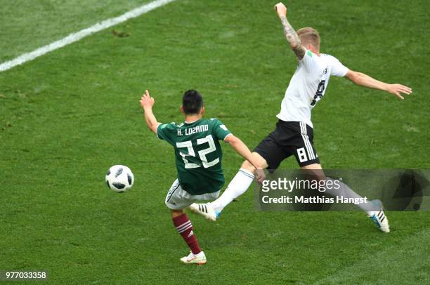 Hirving Lozano of Mexico scores his team's first goal under pressure from Toni Kroos of Germany during the 2018 FIFA World Cup Russia group F match...