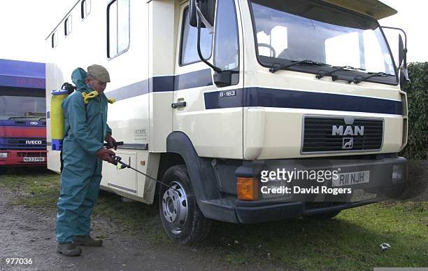 Feb 2001 A course official disinfects the tyres of horse boxes which arrived at Leicester races. This follows the outbreak of Foot and Mouth disease...