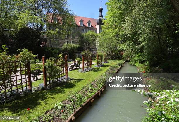 Dpatop - 27 April 2018, Germany, Augsburg: A canal with water from the Lechs running along the herbal garden at the 'Red Gate'. The city of Augsburg...