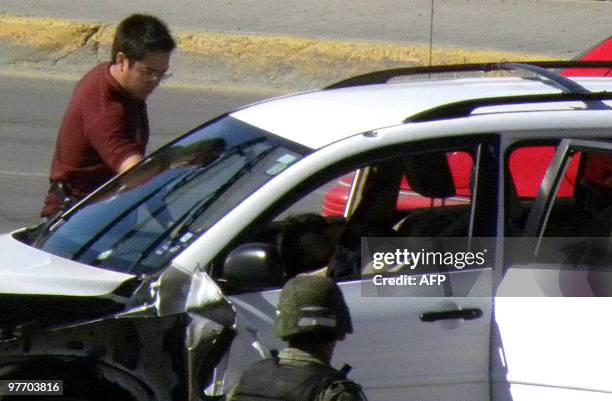 Mexican official checks the scene where three US' Consulate staffers were killed in Ciudad Juarez, Mexico, on March 13, 2010. Ciudad Juarez, with 1.3...