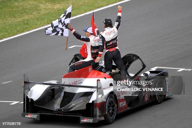 Toyota TS050 Hybrid LMP1's drivers Spain's Fernando Alonso and Switzerland's Sebastien Buemi celebrate after winning the 86th edition of the 24h du...