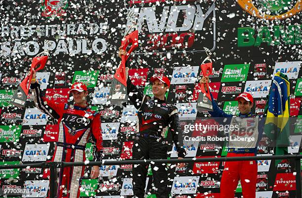 Will Power driver of the Verizon Team Penske Dallara Honda lifts the winner's trophy on the podium after winning the IZOD IndyCar Series Sao Paulo...