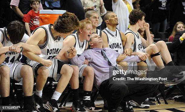 Potomac Falls Head Coach Jeff Hawes sits with his team watching Pete Simoneau sink a free throw in the last seconds of the game. Potomac Falls beats...